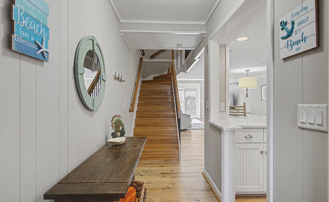 Step into your coastal haven where beach-inspired decor and warm wood floors welcome you home after days of seaside adventures.