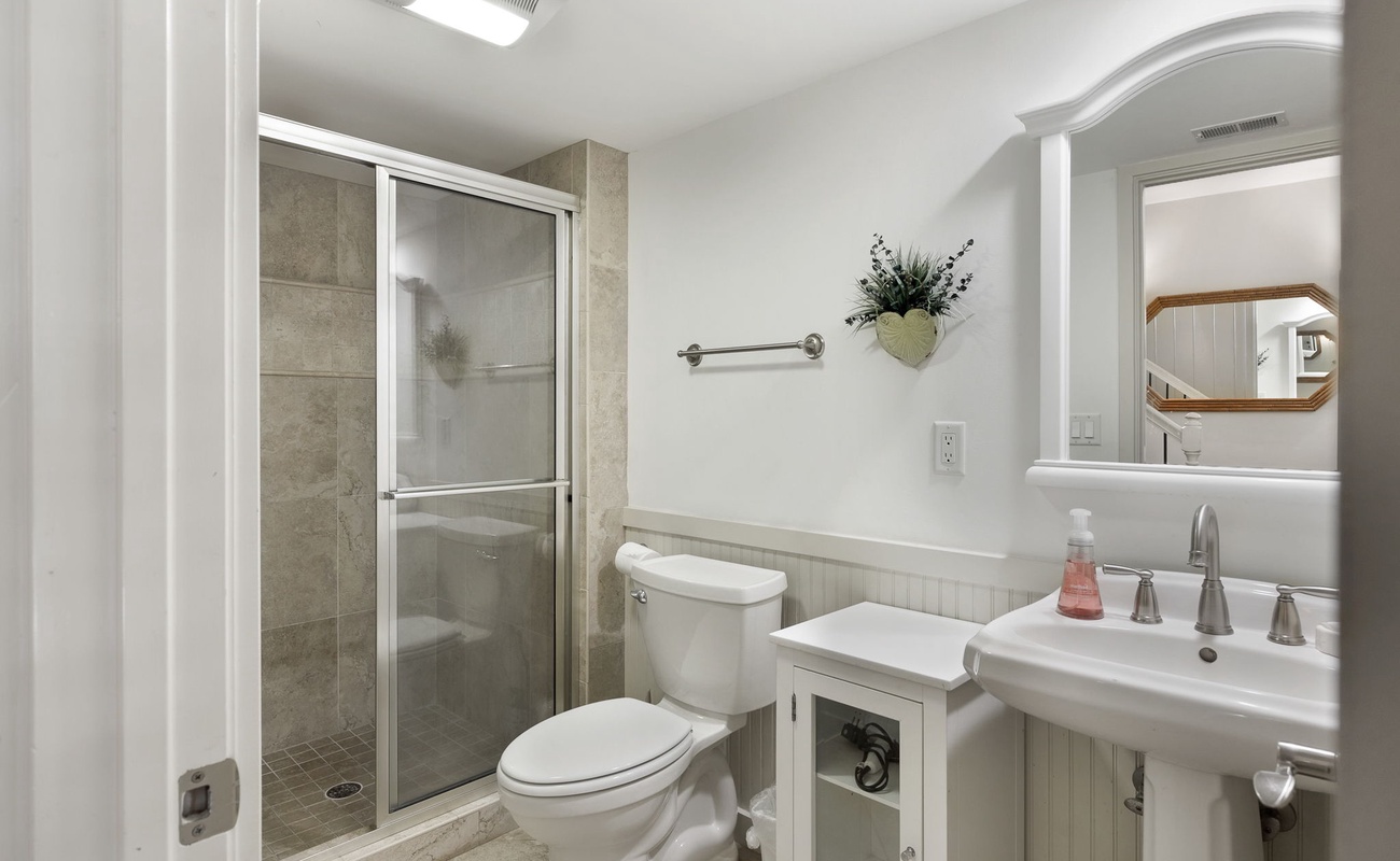 Step into your pristine bathroom featuring a spacious walk-in shower, elegant fixtures, and thoughtful touches that make your stay comfortable.