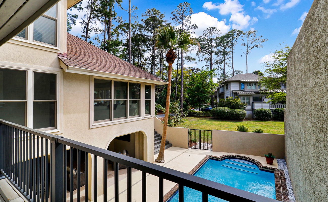 Step onto your private balcony and soak in the tranquil pool views surrounded by lush landscaping and towering trees.