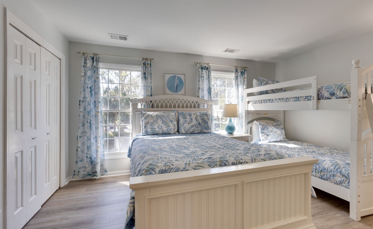 Sleep peacefully in your coastal-themed bedroom featuring a cozy bunk bed and queen bed, perfect for families or friends traveling together.