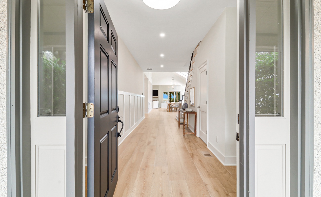 Step into your bright, welcoming hallway with gleaming hardwood floors leading to the heart of your home.