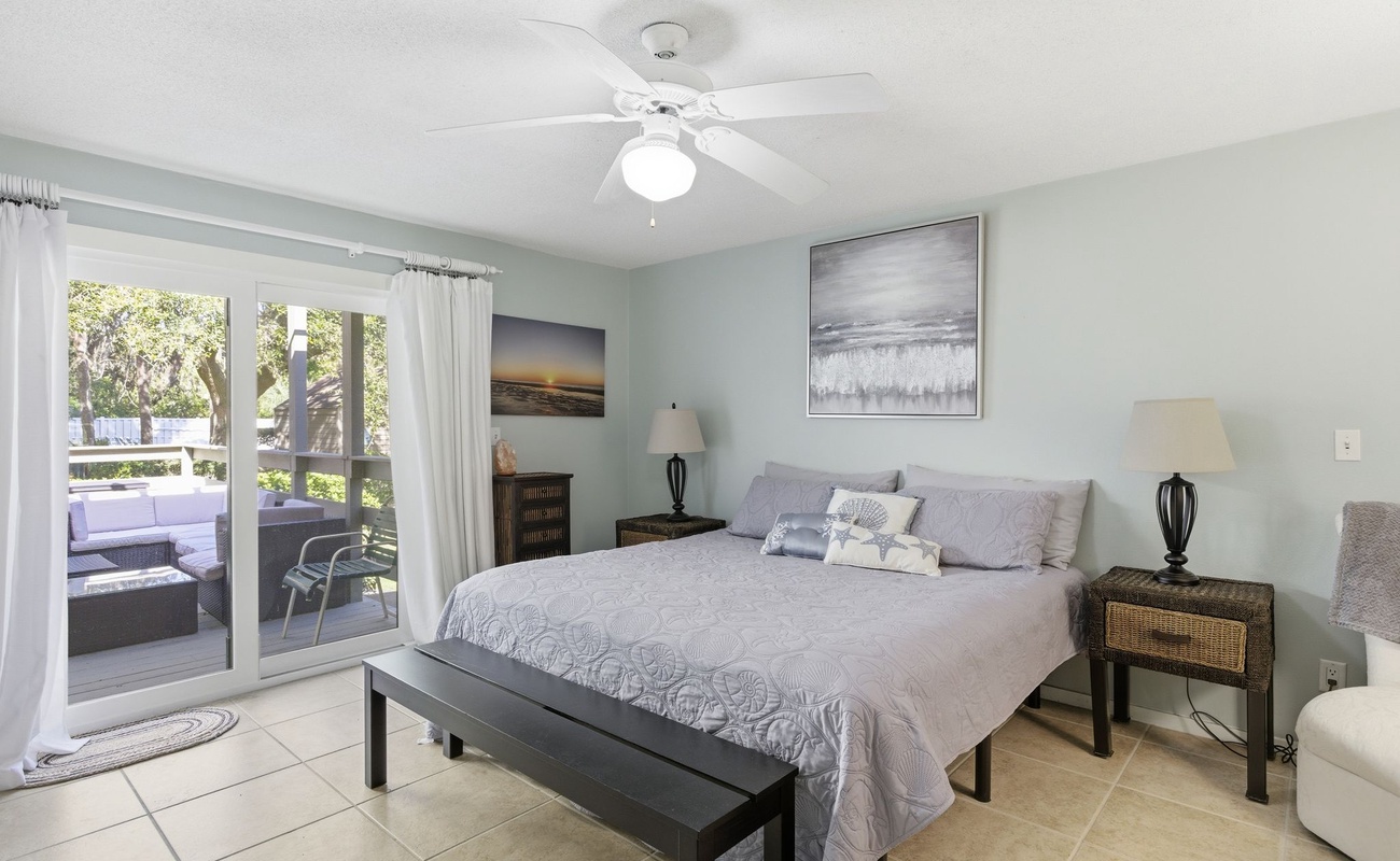 Your serene bedroom sanctuary features a plush king bed and opens to your private balcony where you can unwind with garden views.