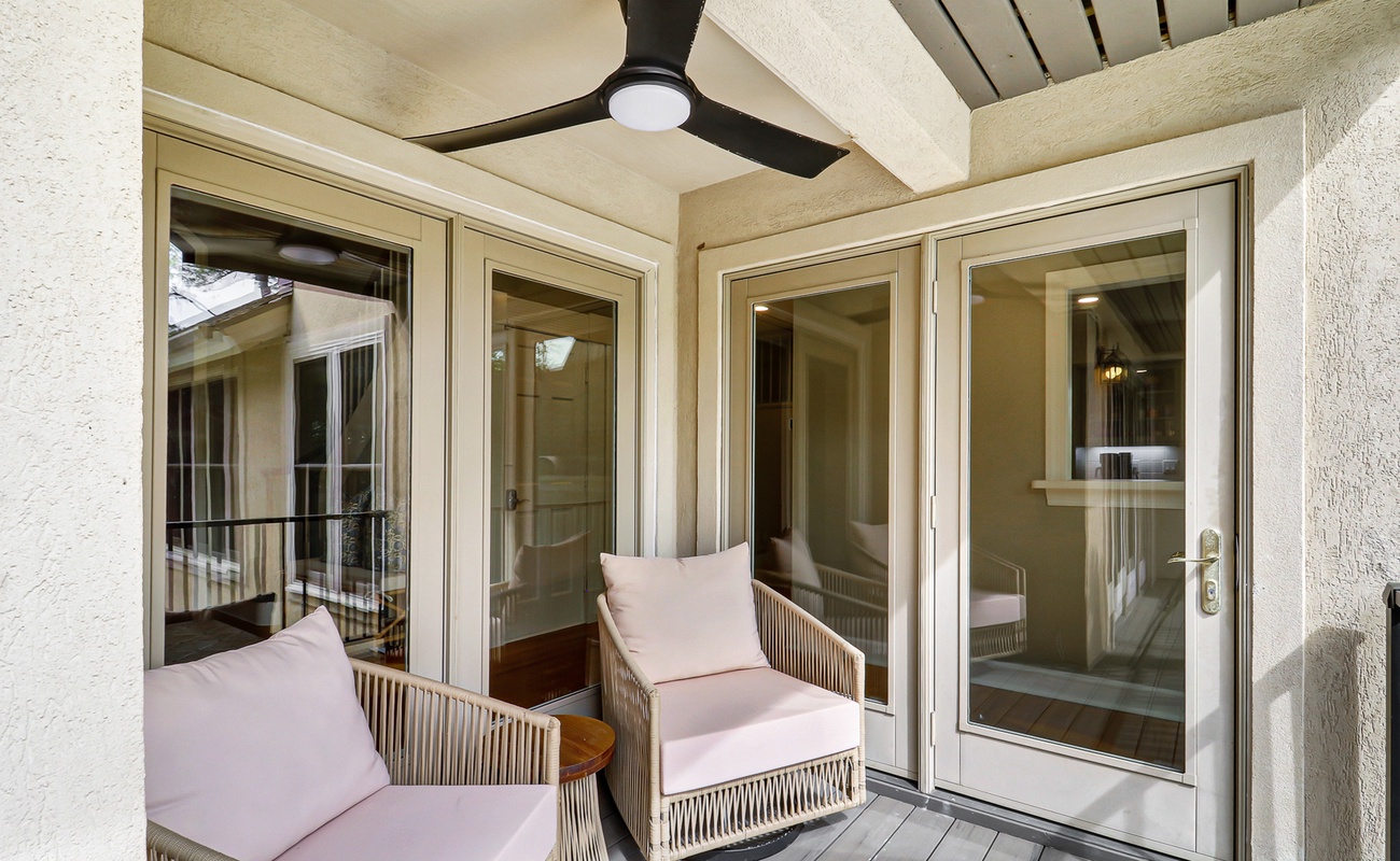 Relax on your private balcony with plush seating and overhead fan, perfect for morning coffee or evening unwinding.