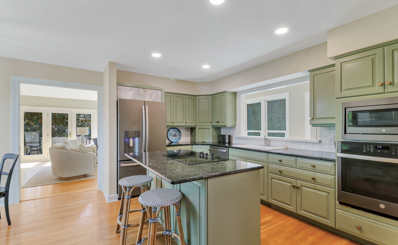 Your fully-equipped kitchen awaits with granite countertops, stainless steel appliances, and a convenient breakfast bar for morning coffee conversations.
