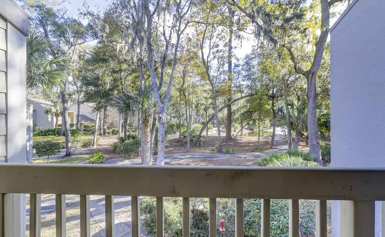 Step onto your private balcony and breathe in the fresh air while enjoying peaceful views of mature trees and landscaped grounds.