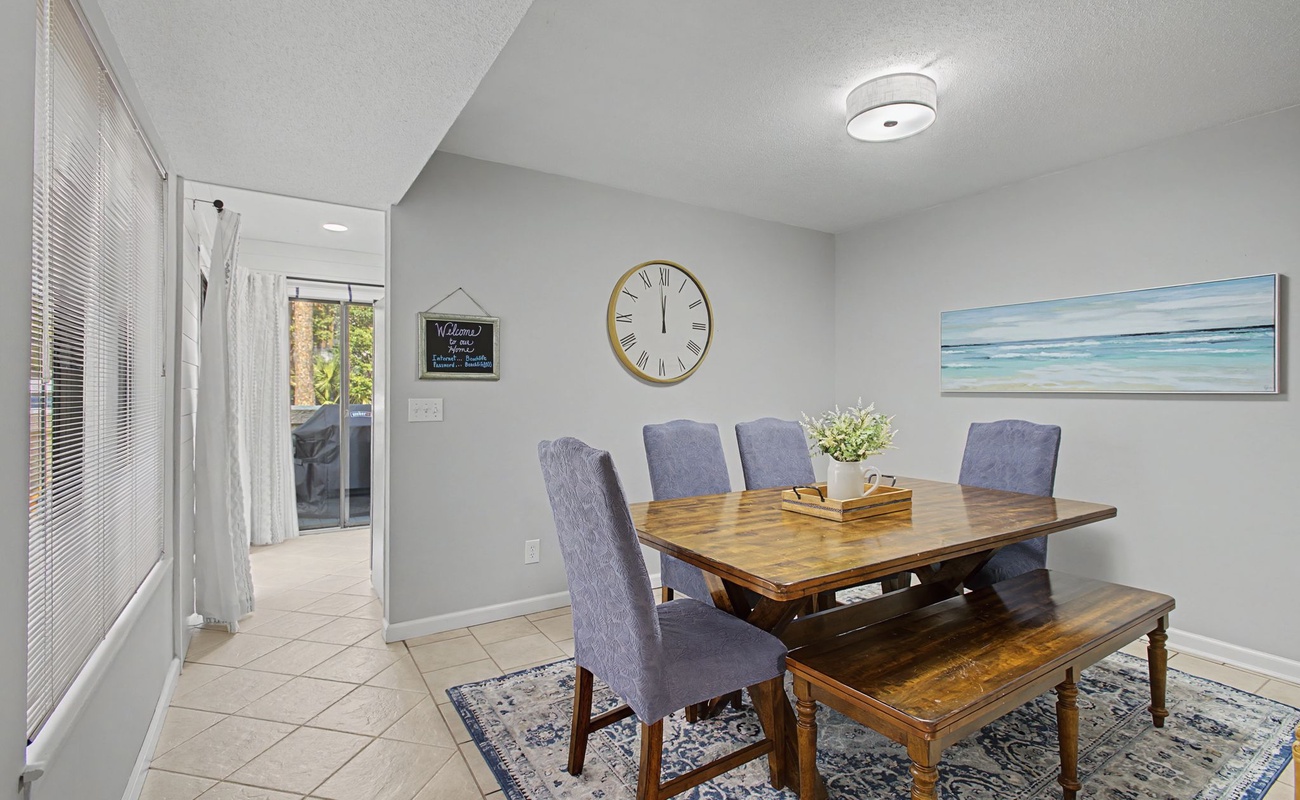 Your bright dining space features a rustic wooden table and comfortable seating, perfect for sharing meals and making memories.