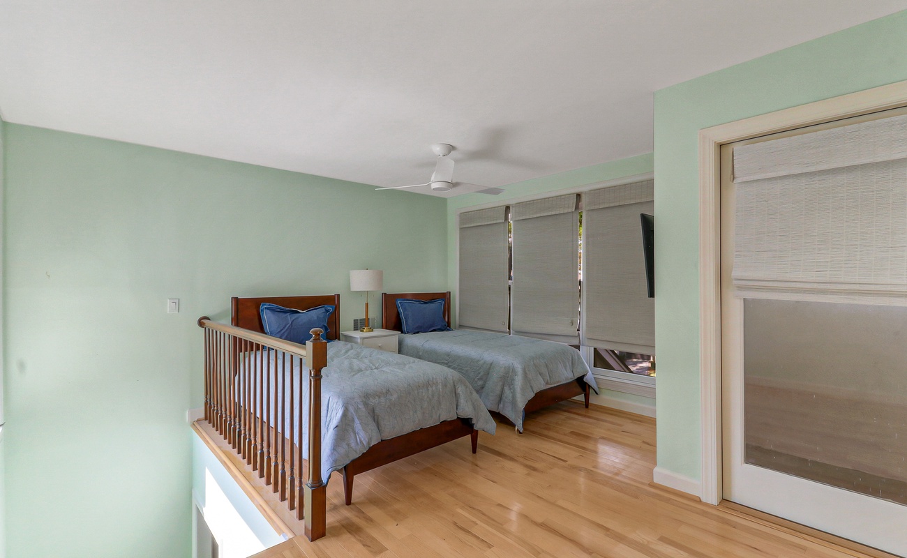 Drift off peacefully in your serene twin bedroom with soothing mint walls, warm hardwood floors, and gentle ceiling fan keeping you comfortable.