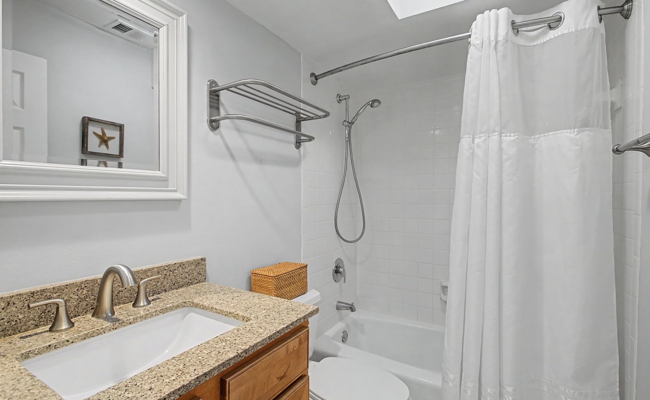 Refresh in your bright, clean bathroom with granite countertops, fresh towels, and a relaxing tub-shower combo.