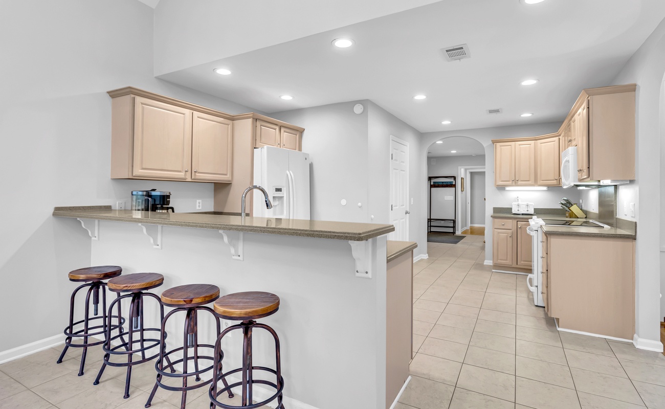Your spacious kitchen invites culinary adventures with modern appliances and a breakfast bar where you can sip morning coffee.