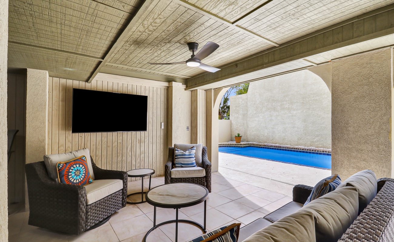 Relax in your private covered patio with pool views, plush seating, and entertainment—perfect for unwinding after desert adventures.