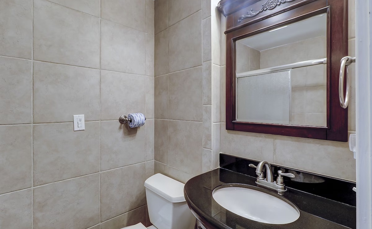 Your elegantly appointed bathroom features rich wood cabinetry and pristine granite countertops for a luxurious start to each day.