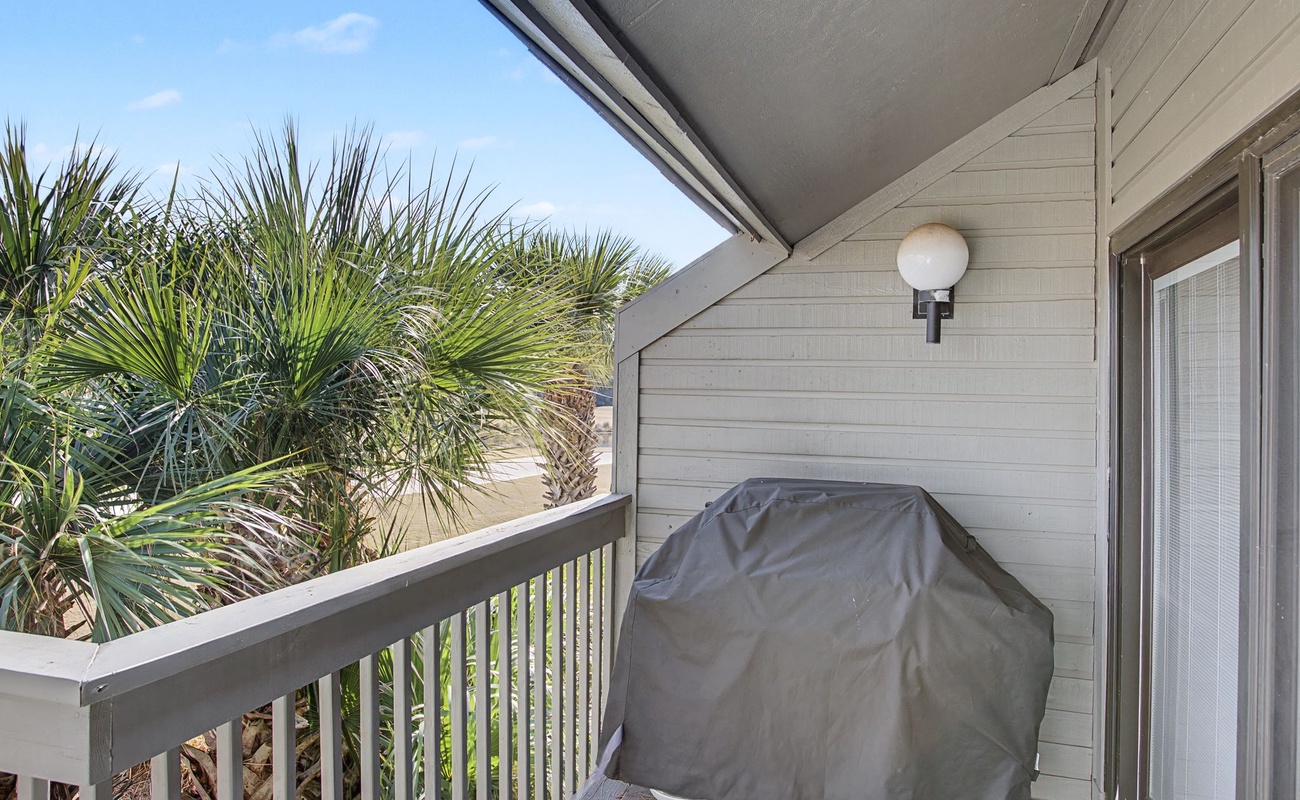 Your private covered balcony offers tropical palm views and a BBQ grill for seaside cooking adventures.