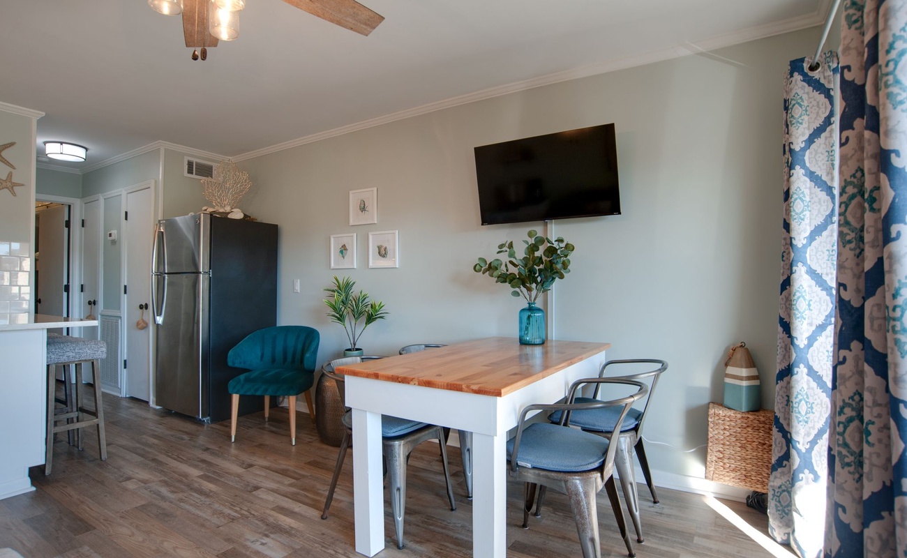 Gather around your stylish dining table for memorable meals in this beautifully furnished space with ocean-inspired touches.