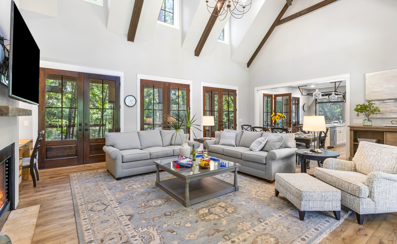 Open Living Space with High-Vaulted Ceilings and Wraparound Porch