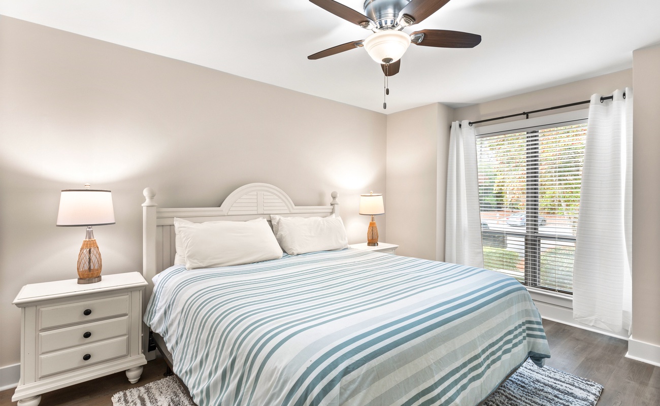 Rest peacefully in your serene bedroom with soft linens, gentle ceiling fan, and calming natural light streaming through the windows.