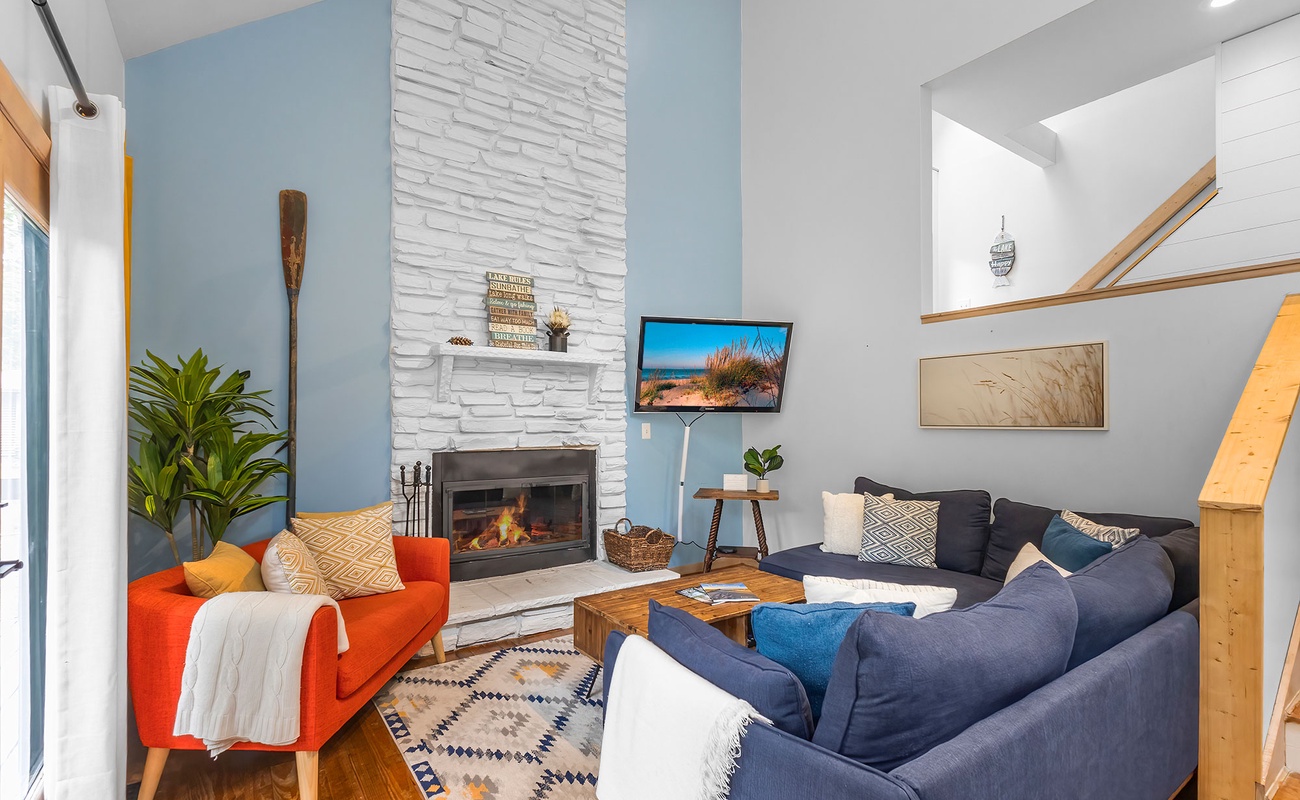 Bold colors, soft cushions, and fireside charm await at La Maison du Lac.