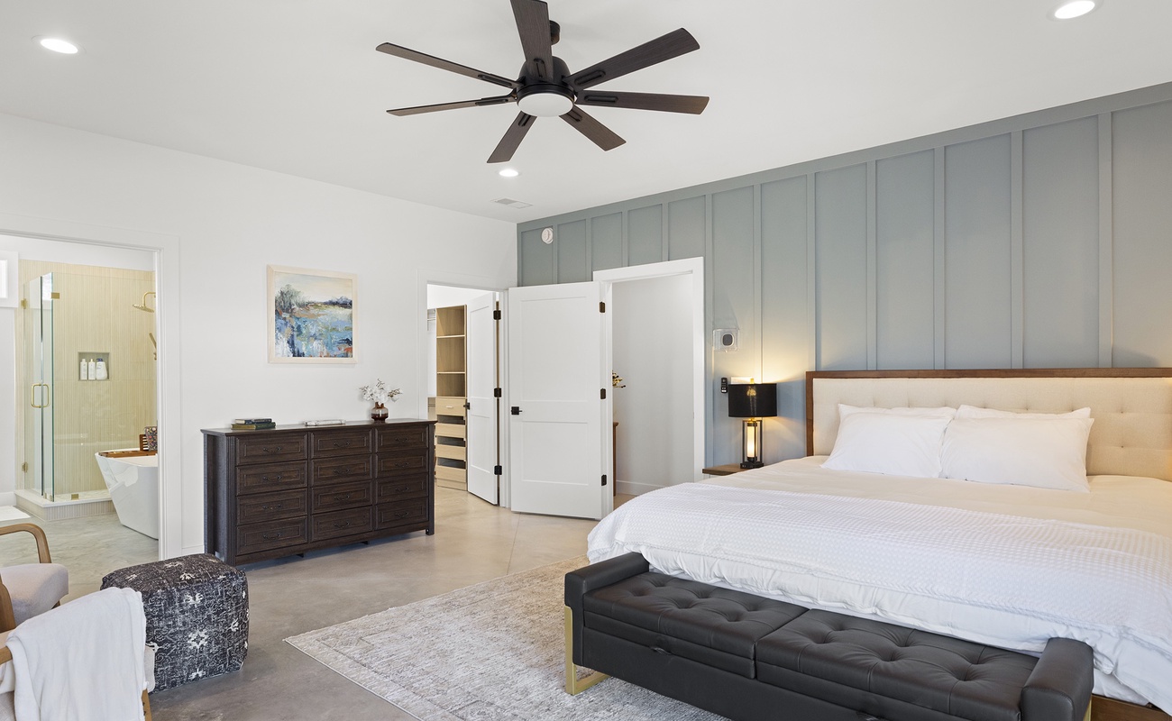 A spacious king bedroom with an ensuite bathroom and walk in closet.
