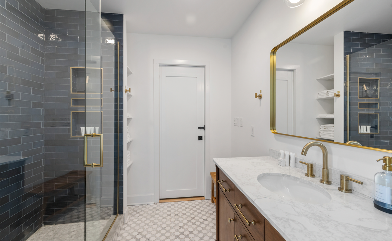 Step into elegance! Where blue tile meets gold fixtures and good vibes.