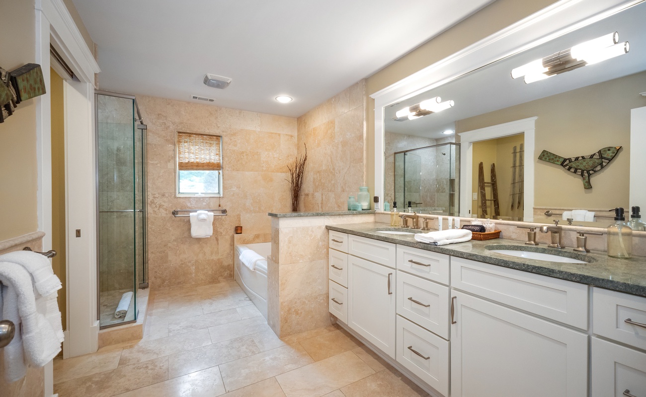 The Master Bathroom includes a chic tiled walk-in shower, tub + 2 vanity sinks.
