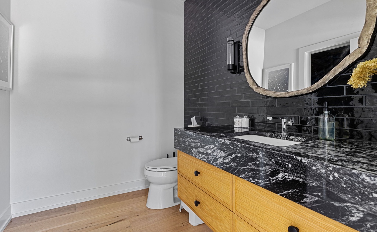 Mixing modern monochrome with rustic wood for the perfect bathroom blend.