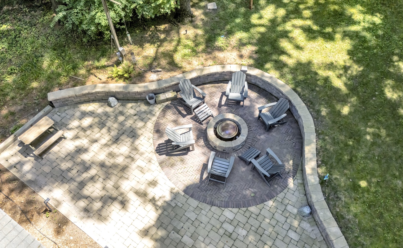 Fire pit vibes: round seating, glowing flames, good times.