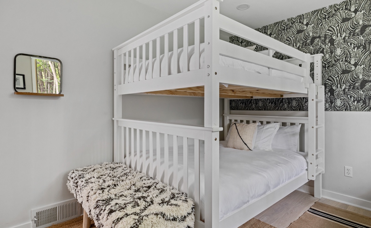 Enjoy a peaceful night's sleep in our charming bunkroom.