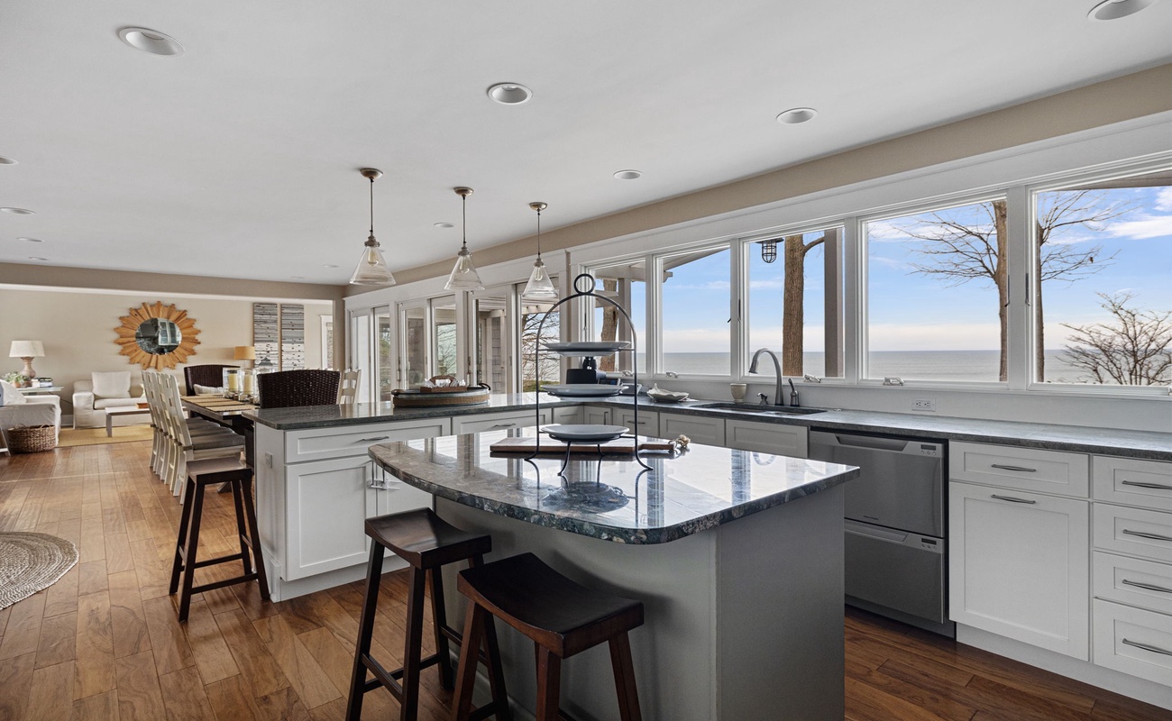 The chic open design joins the sunroom, living room, dining room and kitchen.