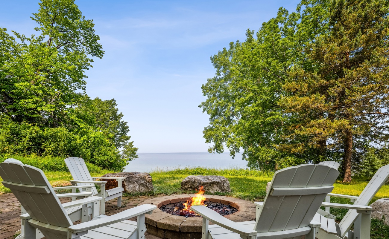 Gather with friends and family around the sandstone patio & firepit overlooking Lake Michigan.