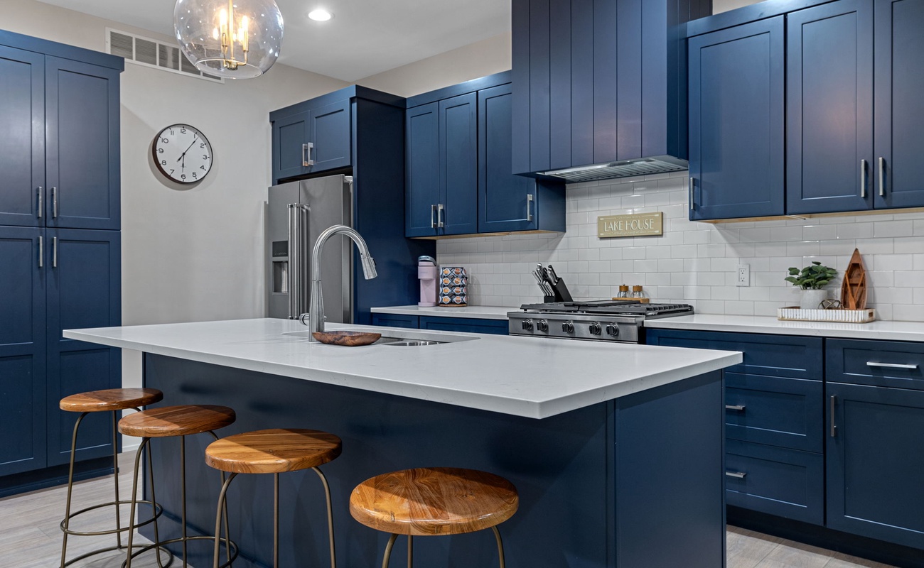 Blue cabinets, white countertops, and a whole lotta style—who needs takeout with a kitchen like this?