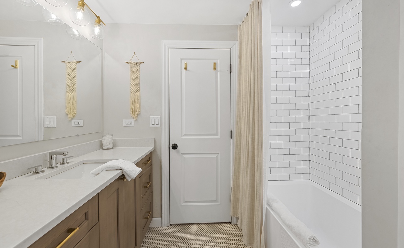 Clean, modern finishes elevate the primary bedroom’s private bath.