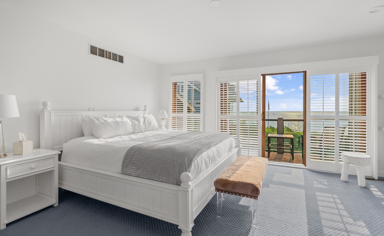 Bedroom 5 is on the upper level & has a king-sized bed and a balcony.