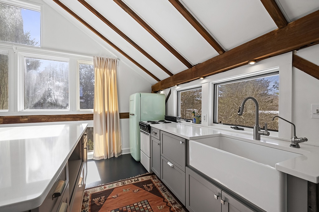 The Loft's kitchen opens to both lounges, keeping everything within easy reach.