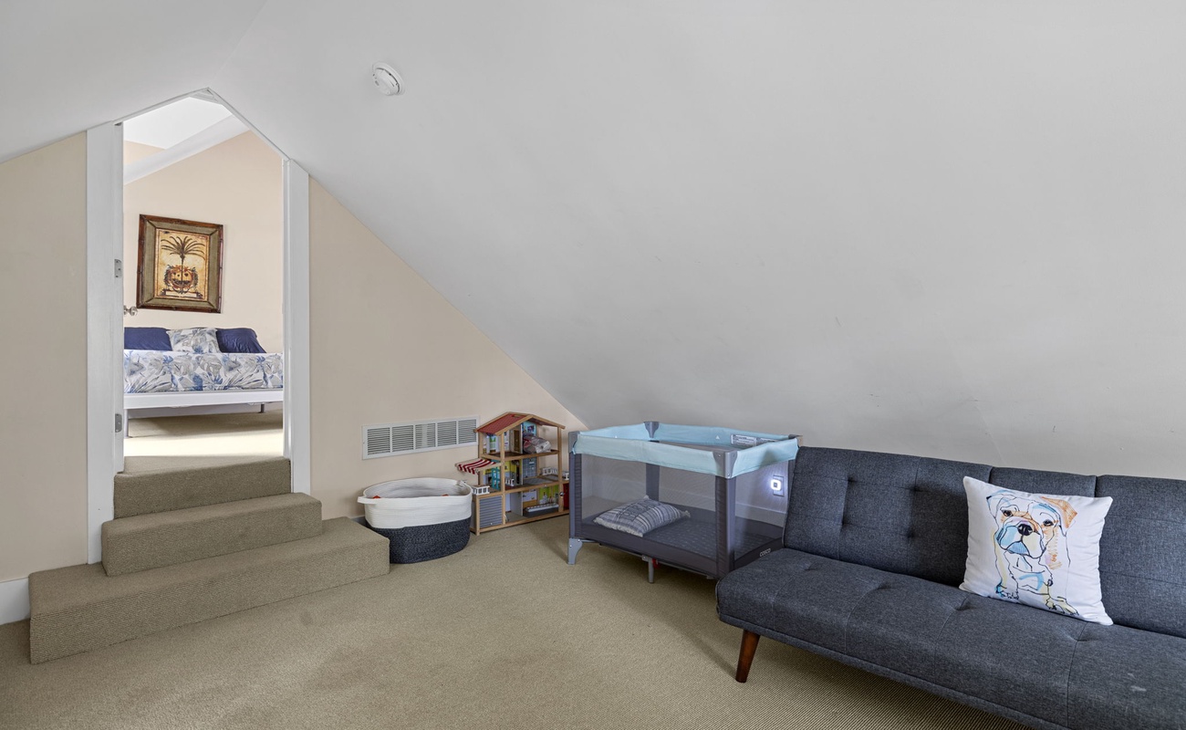 A family room with toys and a crib for guests with kids. Yeah, we've got that.