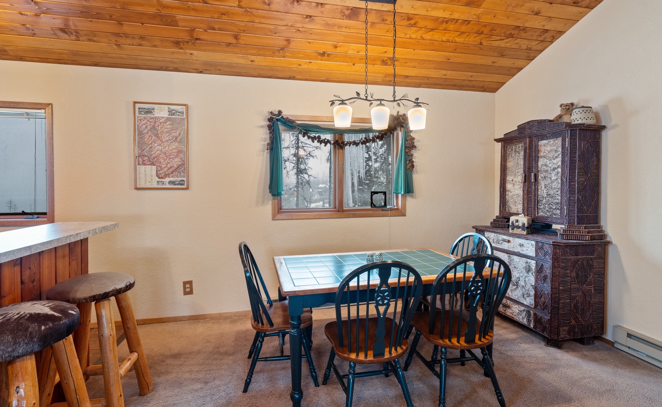 A warm and inviting dining room with a unique tile-topped table.