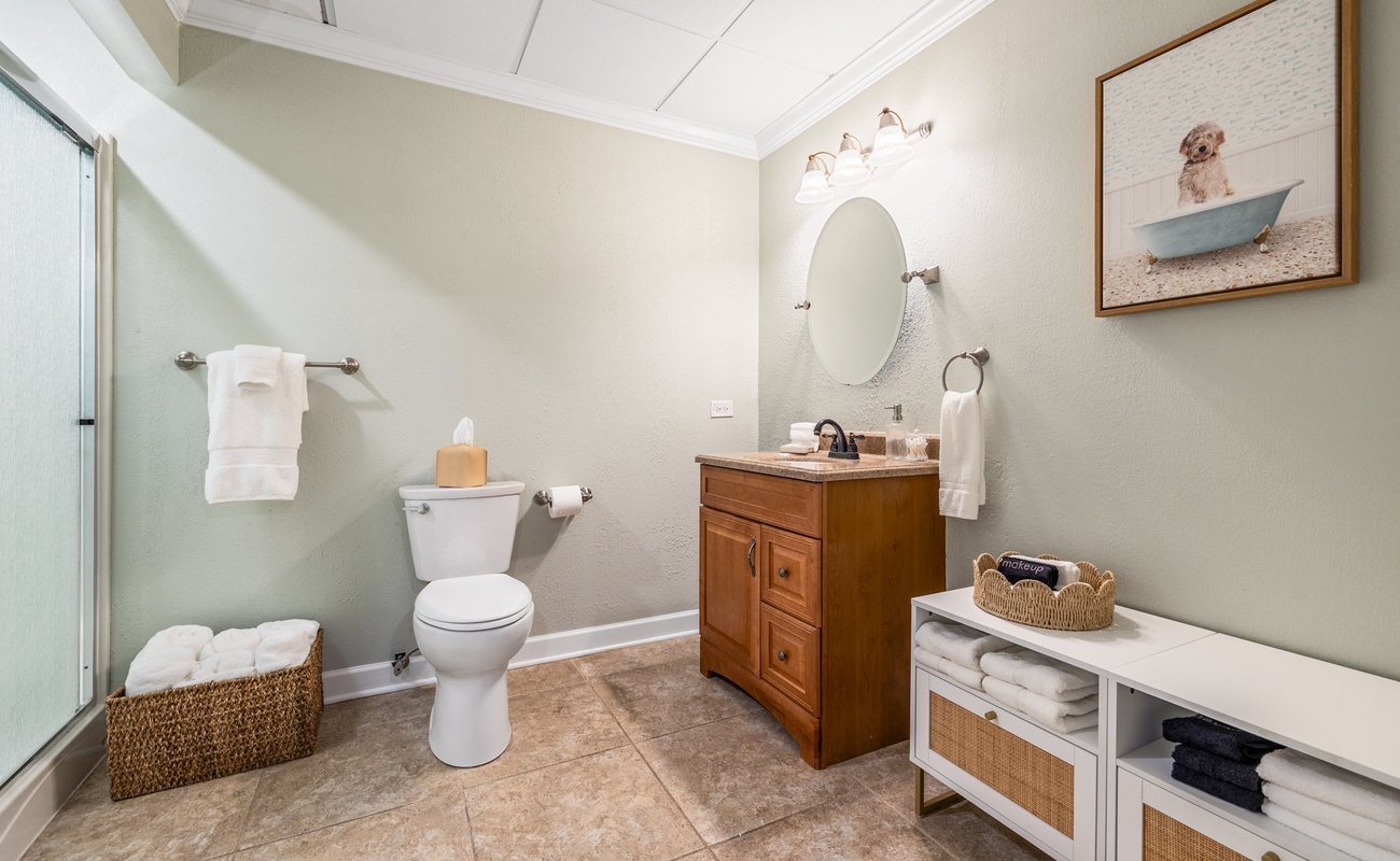 Fresh towels, soft lighting, and even a pup in the tub—every detail says welcome.