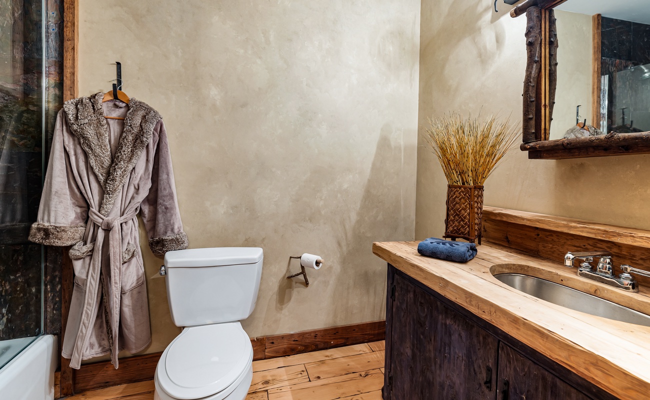 The wooden counter boosts style and brings calm to the bathroom.