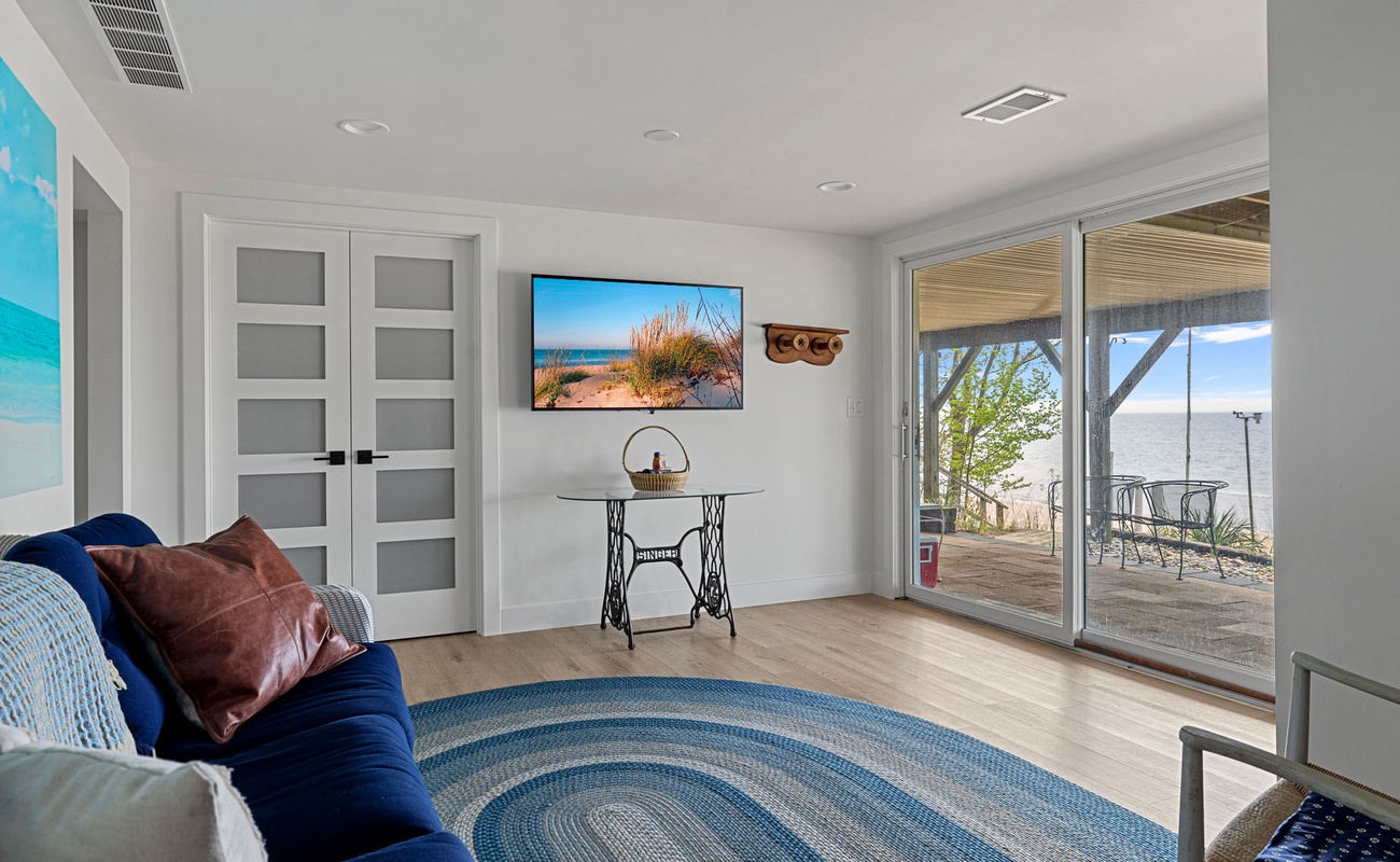 The downstairs family room has plenty of space, cozy seating + a flat-screen TV.