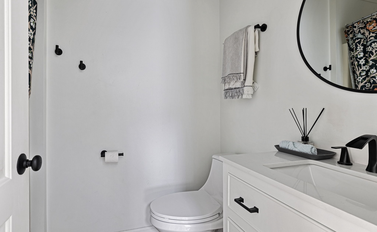 The second bathroom is accentuated by a stone-top vanity and deluxe fixtures.