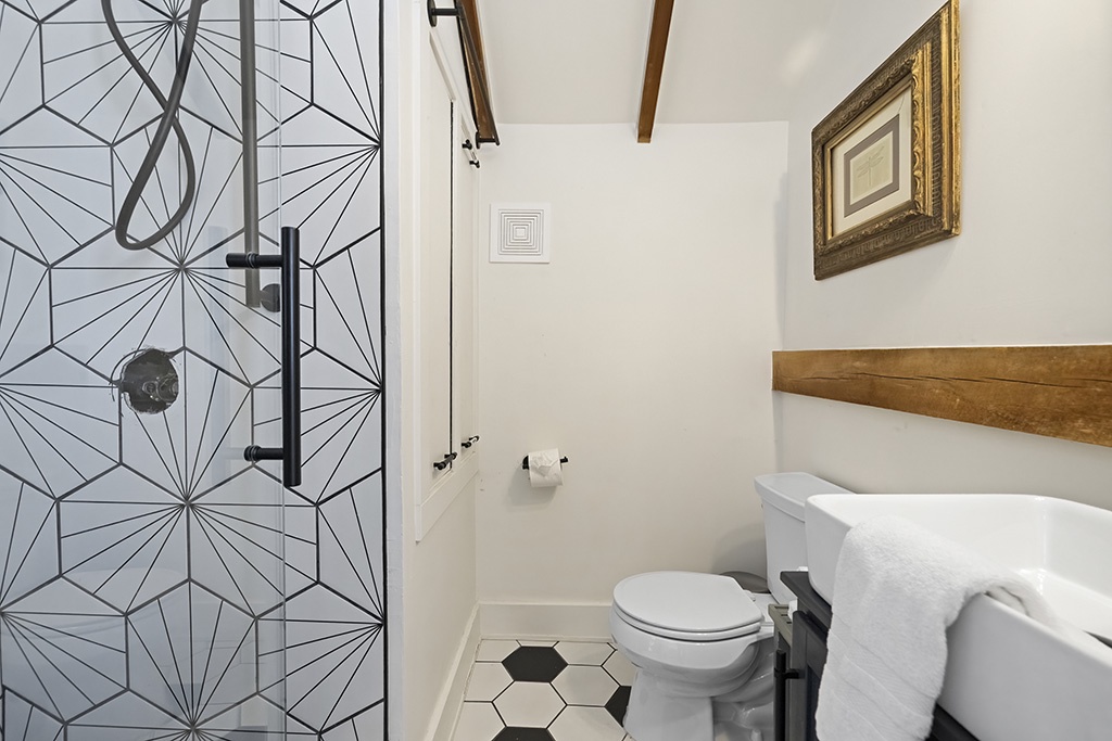 The Loft’s modern bath with bold tile and warm farmhouse touches.