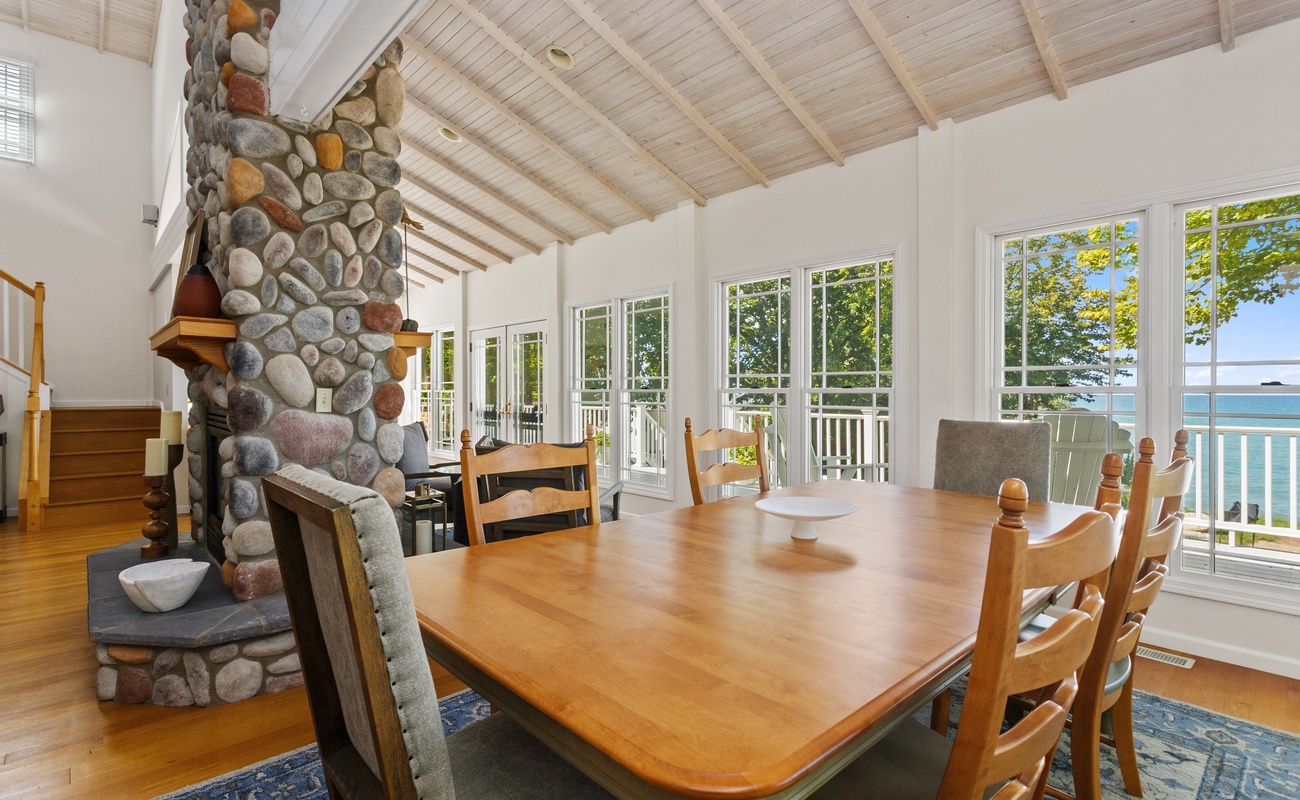 Furnished “upscale cozy” throughout, the spacious living room is drenched in light.