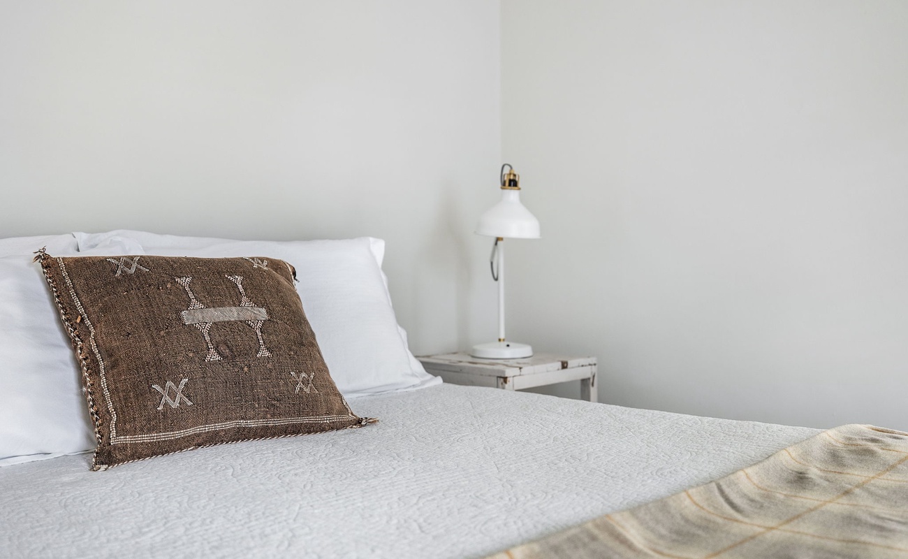 This room whispers, ‘Relax,’ and that pillow adds, ‘But make it stylish.’