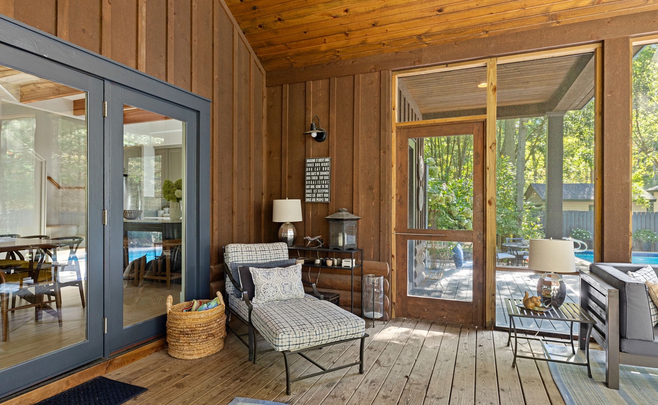 Comfortable seating options within the enclosed porch to relax on.