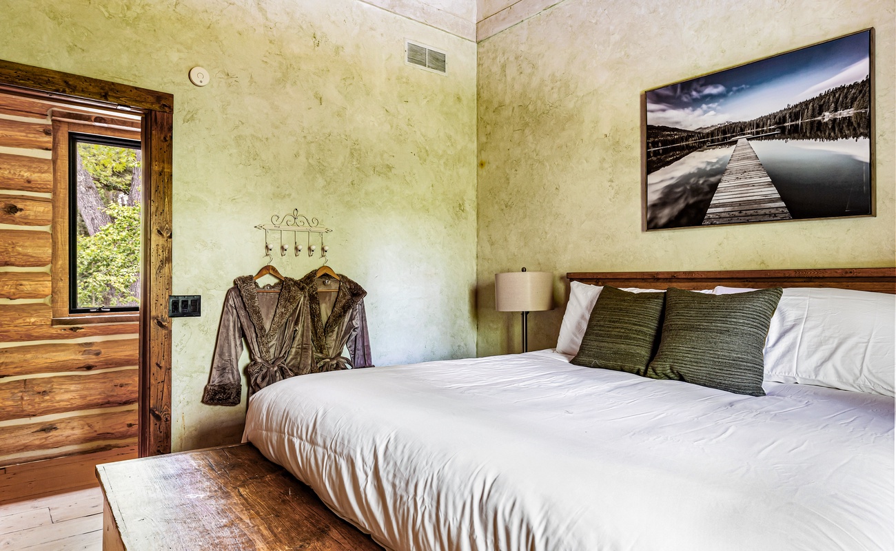 Serene bedroom with a striking painting invites you to unwind in style.