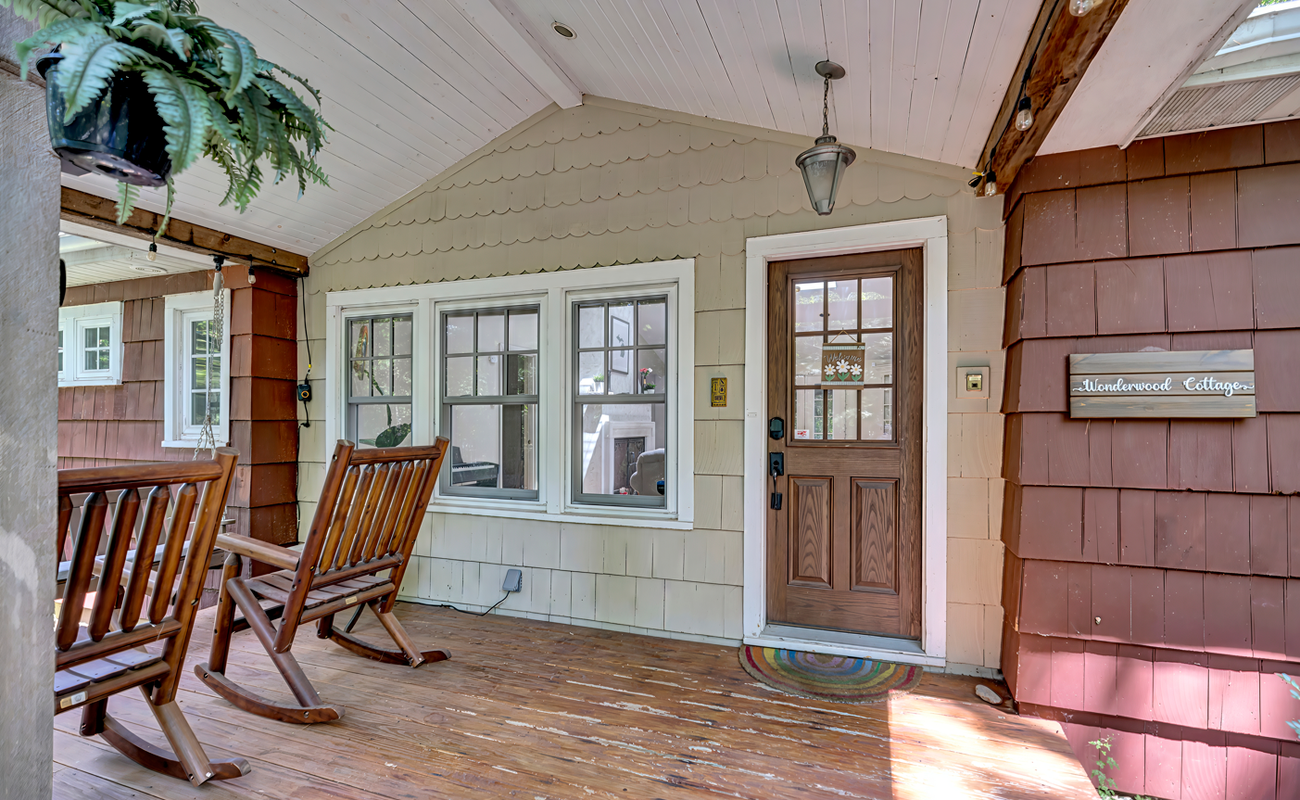 Welcome to Wonderwood Cottage, where the front porch sets the tone for a warm and inviting stay.