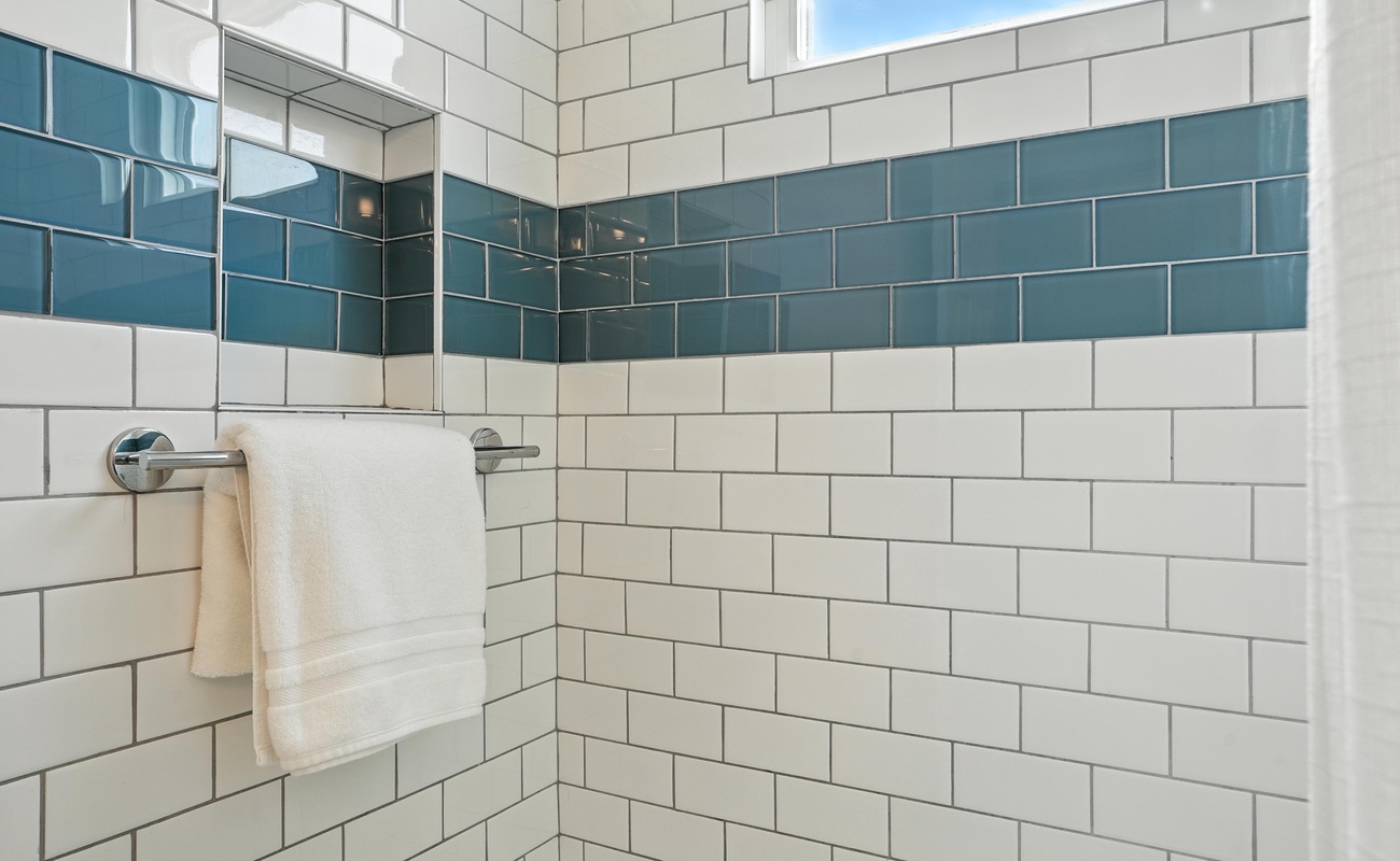 A pop of ocean blue makes this shower feel like a seaside escape.