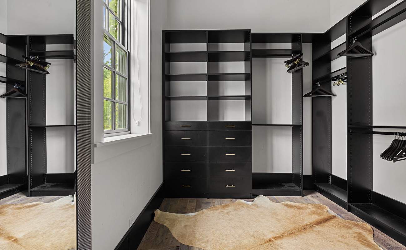 The main bedroom’s enormous walk-in closet is the envy of every guest.