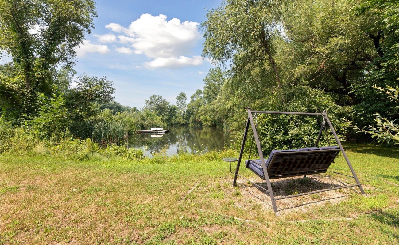 Swing gently beside your private pond.
