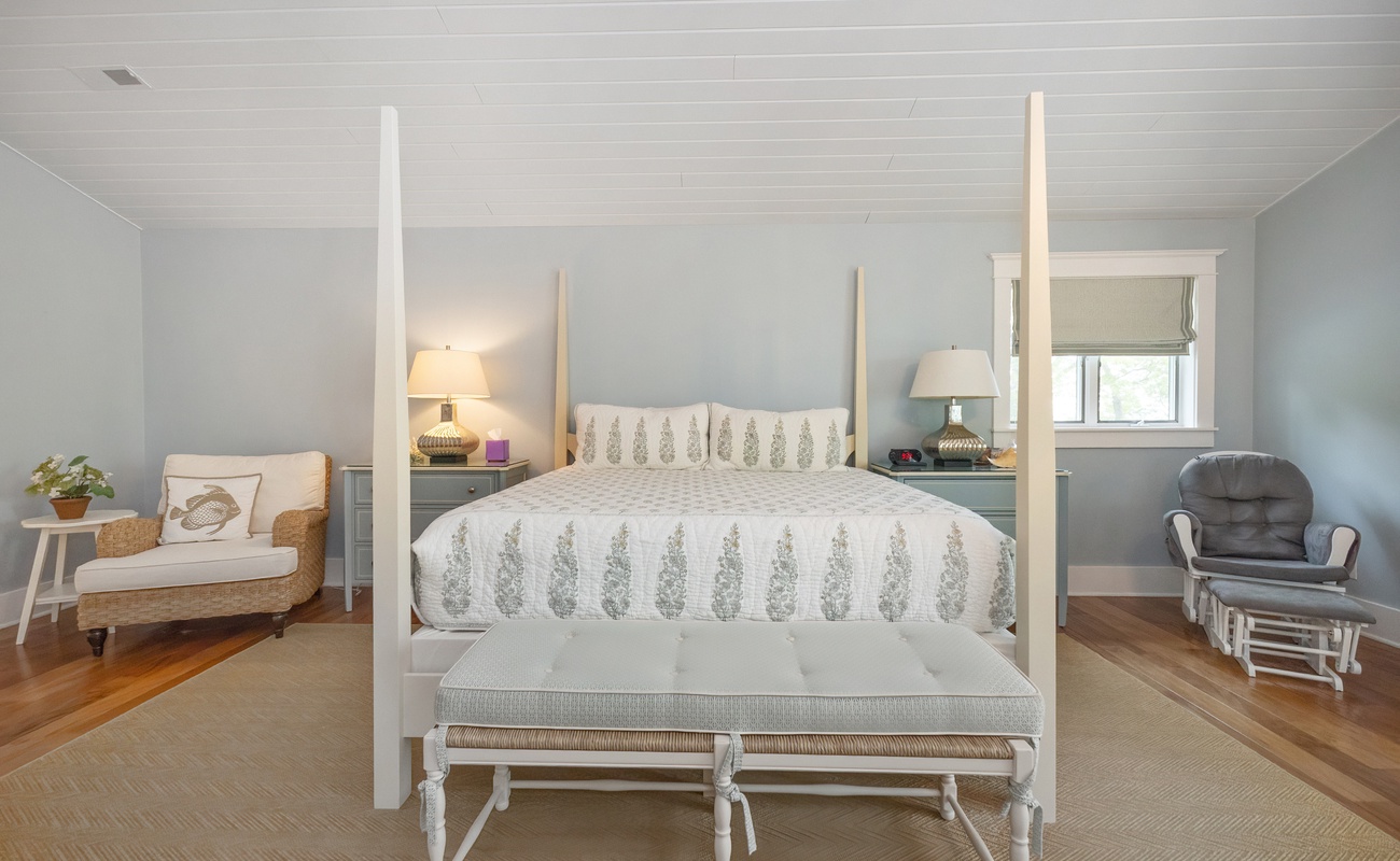 Primary bedroom is on the upper level & has a king-size bed.