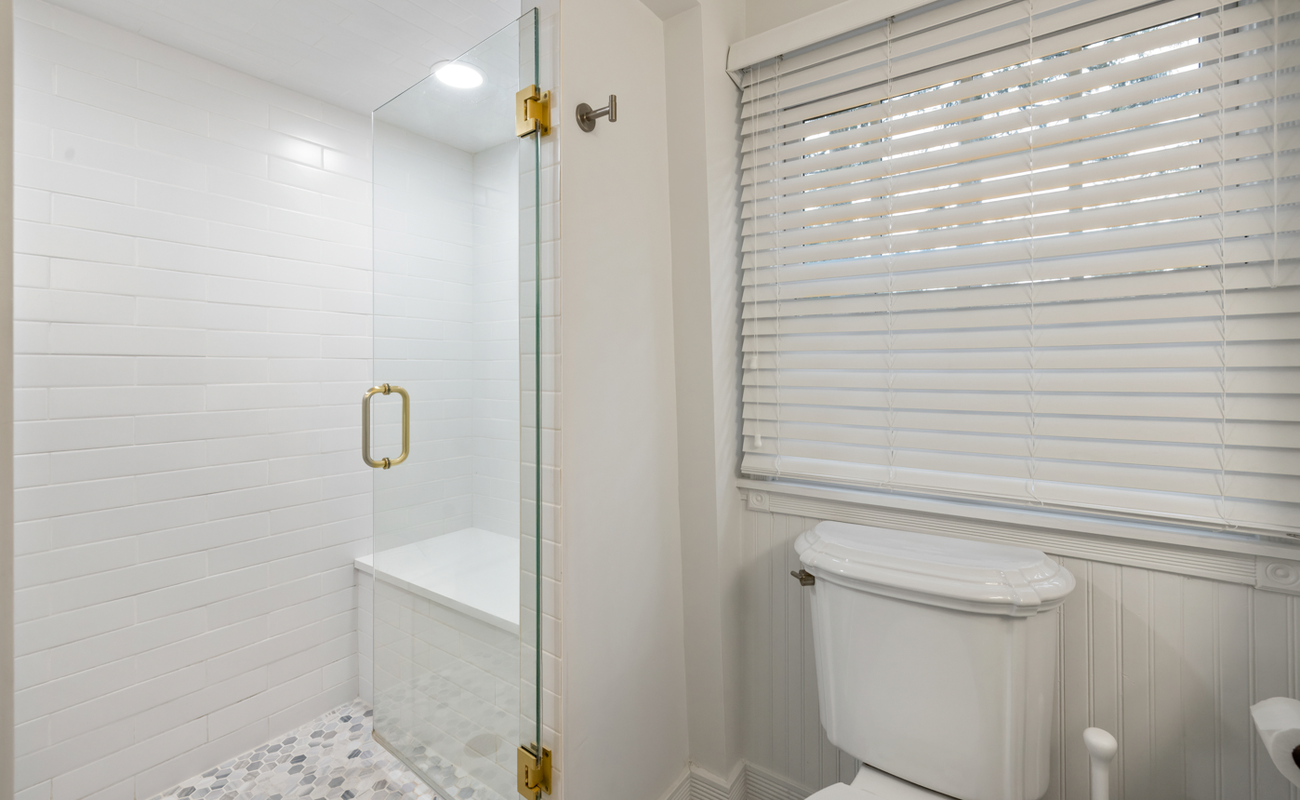 Bright, modern bathroom with glass shower and chic finishes.