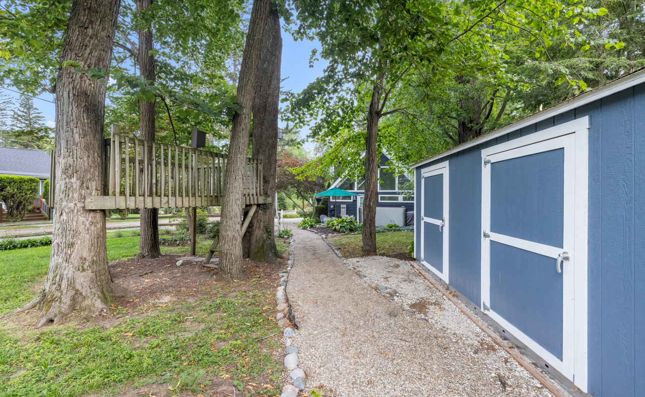 Whimsical treehouse fun along your private garden path.